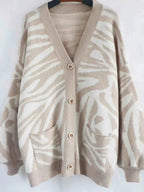 Zebra Print Button Up cardigan in beige and white with button closure, long sleeves, and front pockets in soft knit material