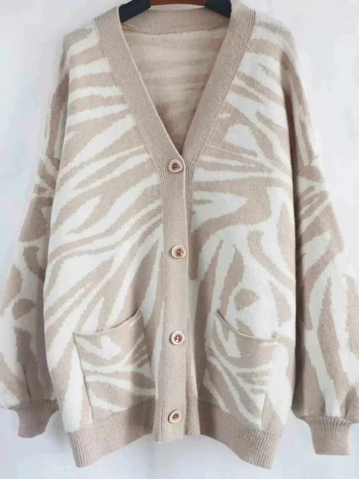 Zebra Print Button Up cardigan in beige and white with button closure, long sleeves, and front pockets in soft knit material