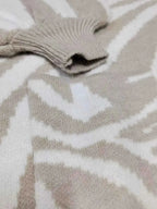 Zebra Print Button Up cardigan with beige and white zebra stripes, soft knit texture, and ribbed cuff detail