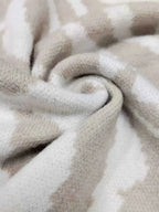 Zebra Print Button Up fabric close-up in beige and white, showing soft polyester material with slight stretch
