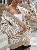 Zebra Print Button Up cardigan in beige and white with long sleeves, button closure, and front pockets on knit fabric