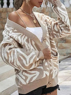 Zebra Print Button Up cardigan in beige and white with long sleeves, button closure, and front pockets on knit fabric