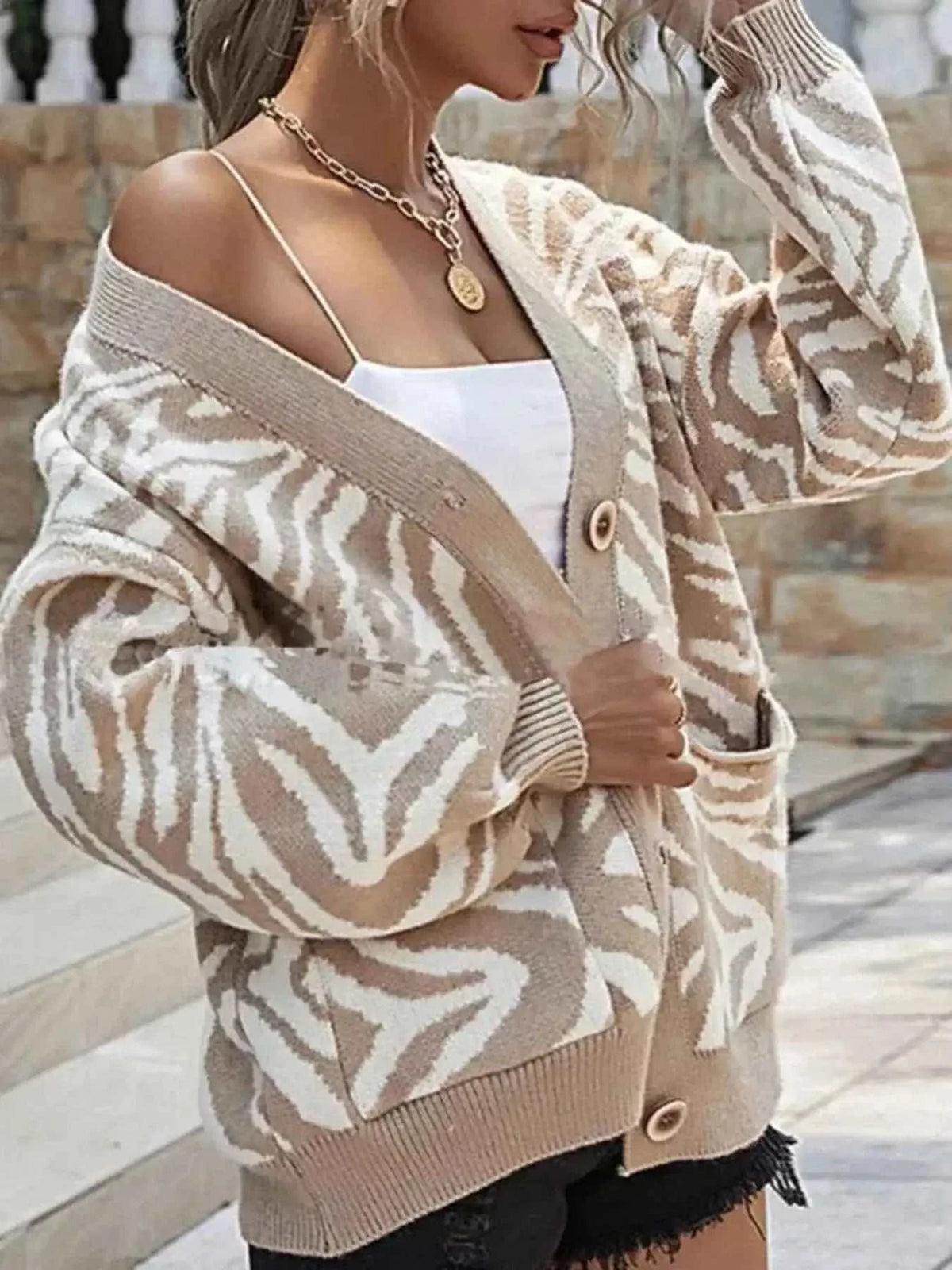 Zebra Print Button Up cardigan in beige and white with long sleeves, button closure, and front pockets on knit fabric