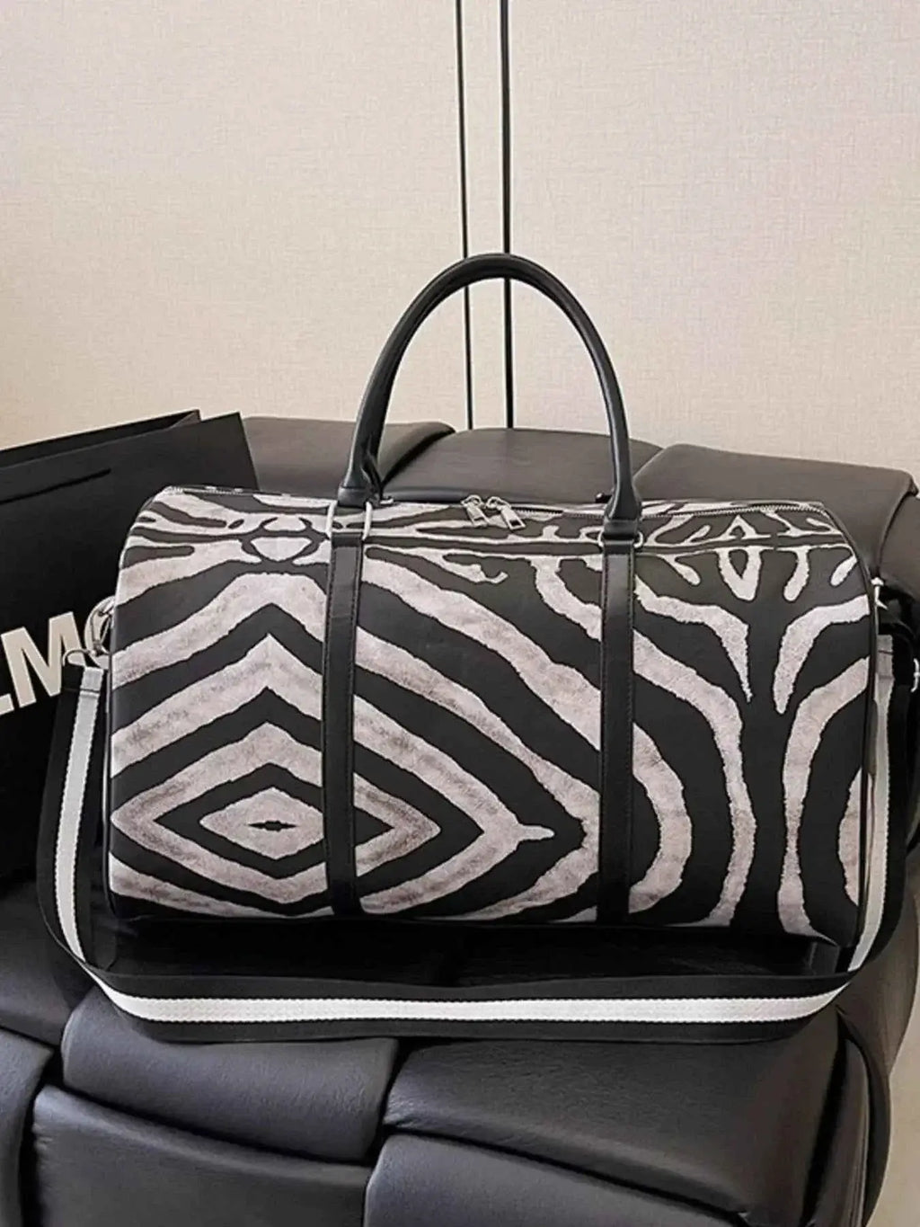 Large Zebra Print Duffle Bag in black and white PU leather with bold abstract zebra pattern and black handles