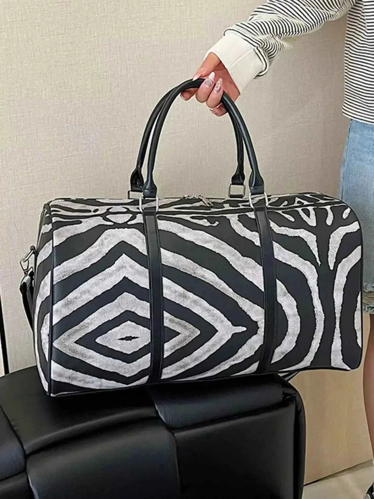 Large Zebra Print Duffle Bag in black and white PU leather with dual handles and geometric zebra pattern