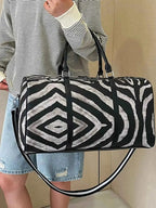 Large Zebra Print Duffle Bag in black and white PU leather with bold geometric zebra pattern and dual handles