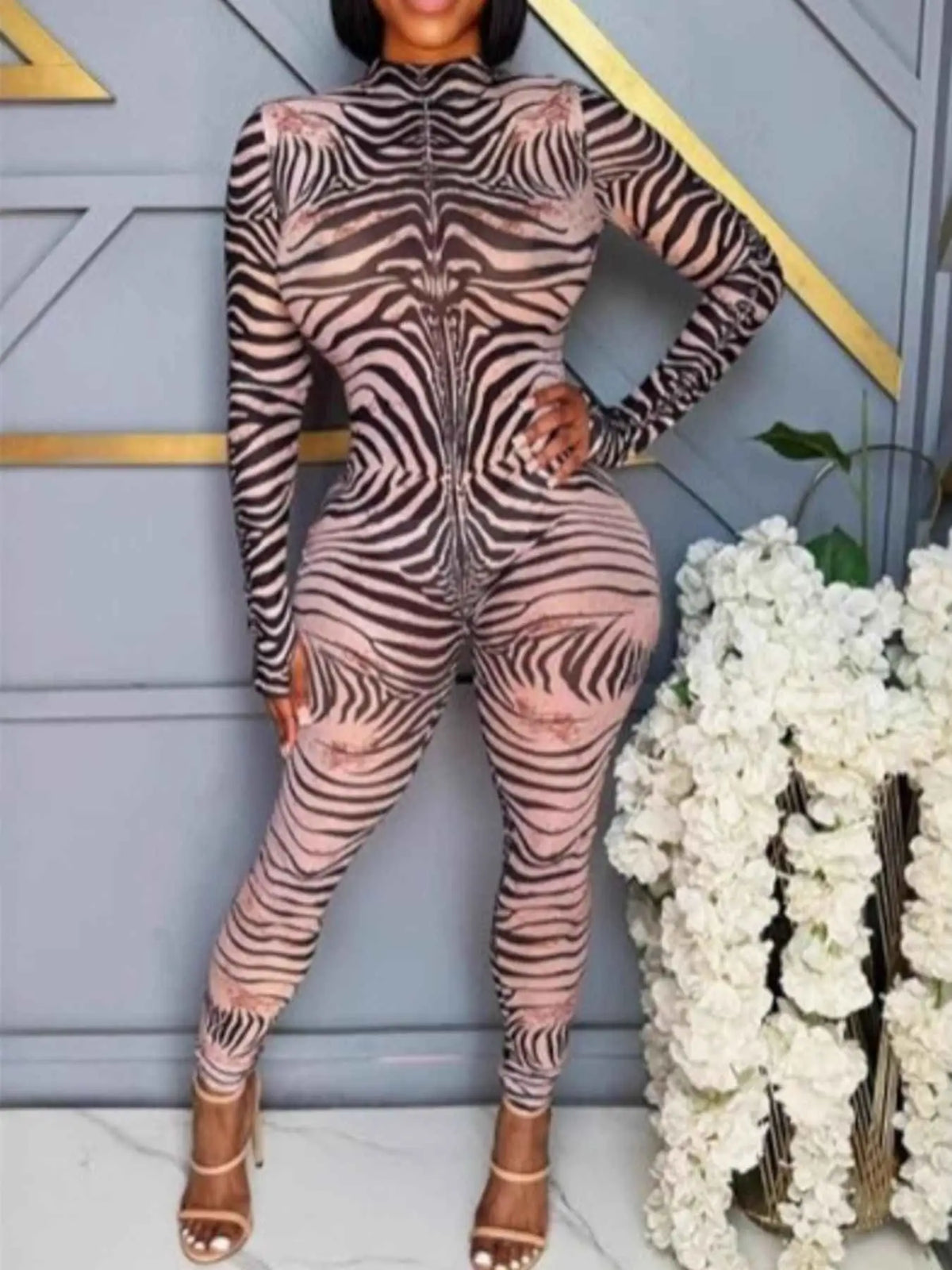 Zebra Print long sleeve bodycon jumpsuit in black and beige polyester with zipper detail and fitted silhouette