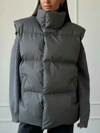 Zip Up Turtleneck Vest in dark grey padded polyester with a high padded collar and a smooth, quilted finish