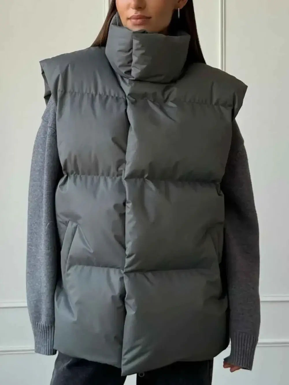 Zip Up Turtleneck Vest in dark grey padded polyester with a high padded collar and a smooth, quilted finish