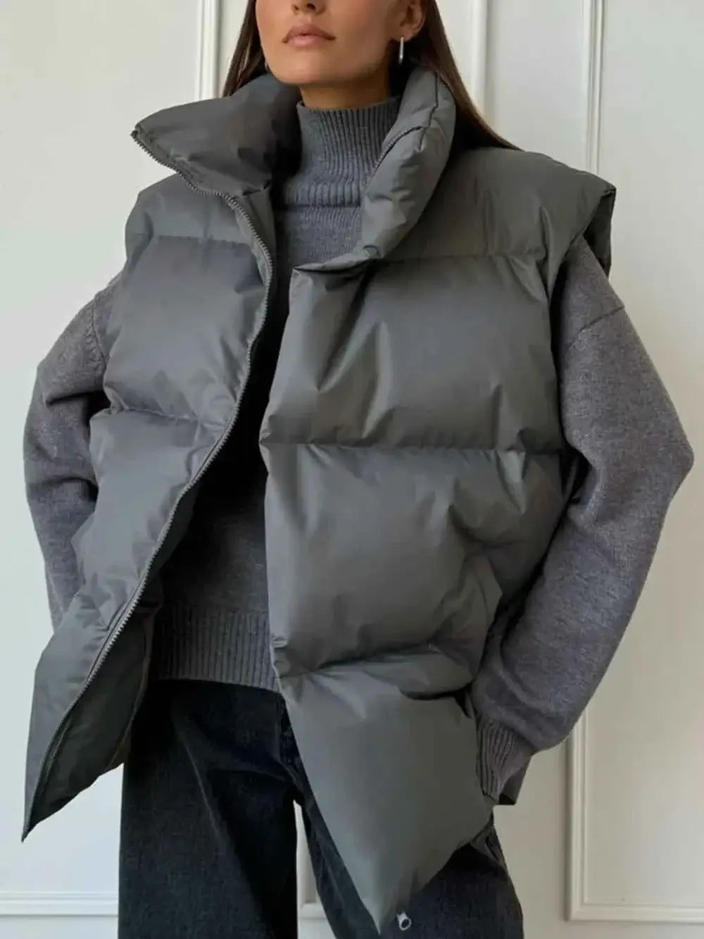 Zip Up Turtleneck Vest in grey polyester with puffy quilted design and high collar with zipper closure